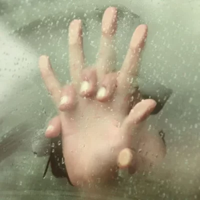 hands together on steamed glass